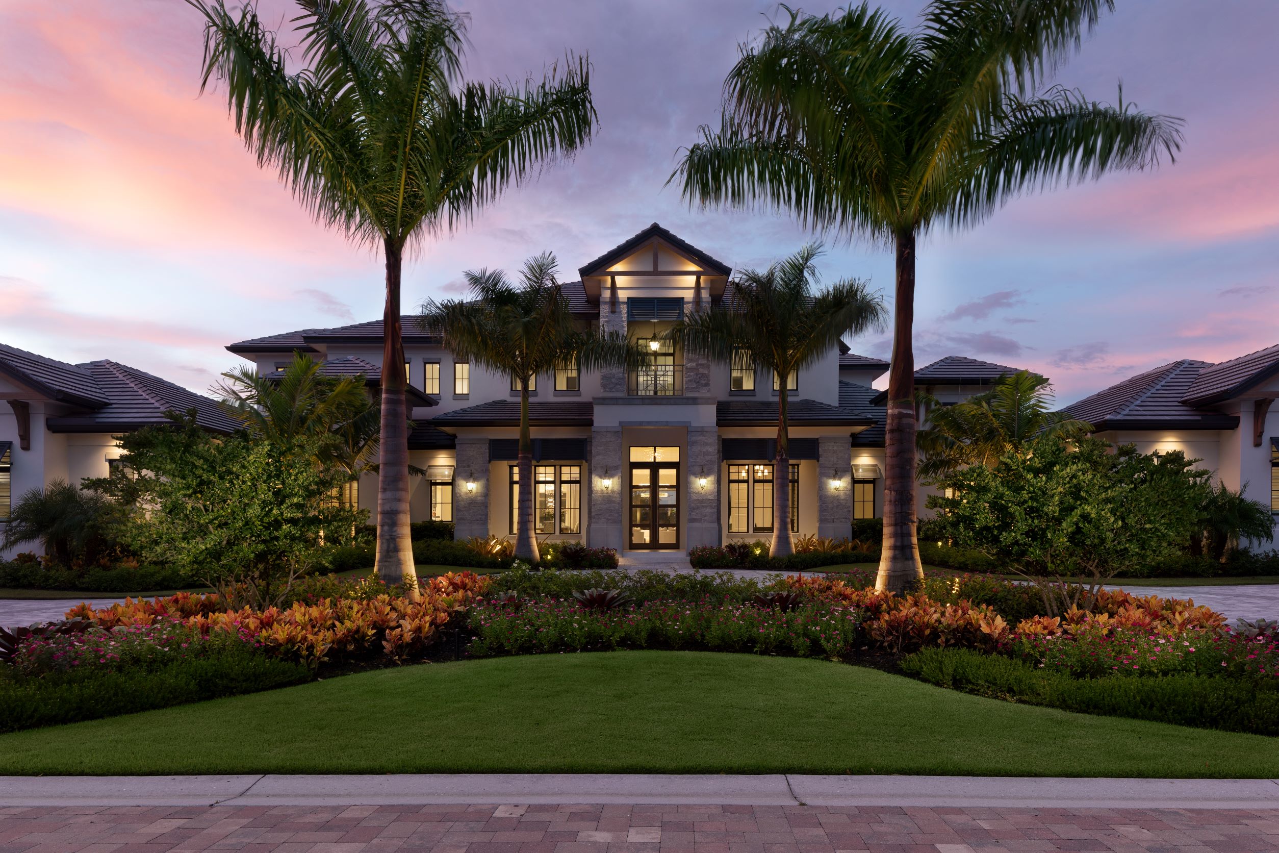 south-florida-design-front-elevation-color-photo-at-dusk-of-the-2-story-kinsley-manor-house-plan