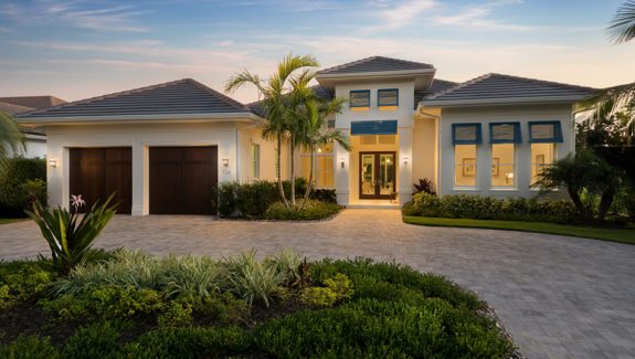 4 bedroom waterfront house plan features open floor plan, great room, island kitchen with pantry, study and covered lanai with outdoor kitchen designed by South Florida Design located in Naples, Florida