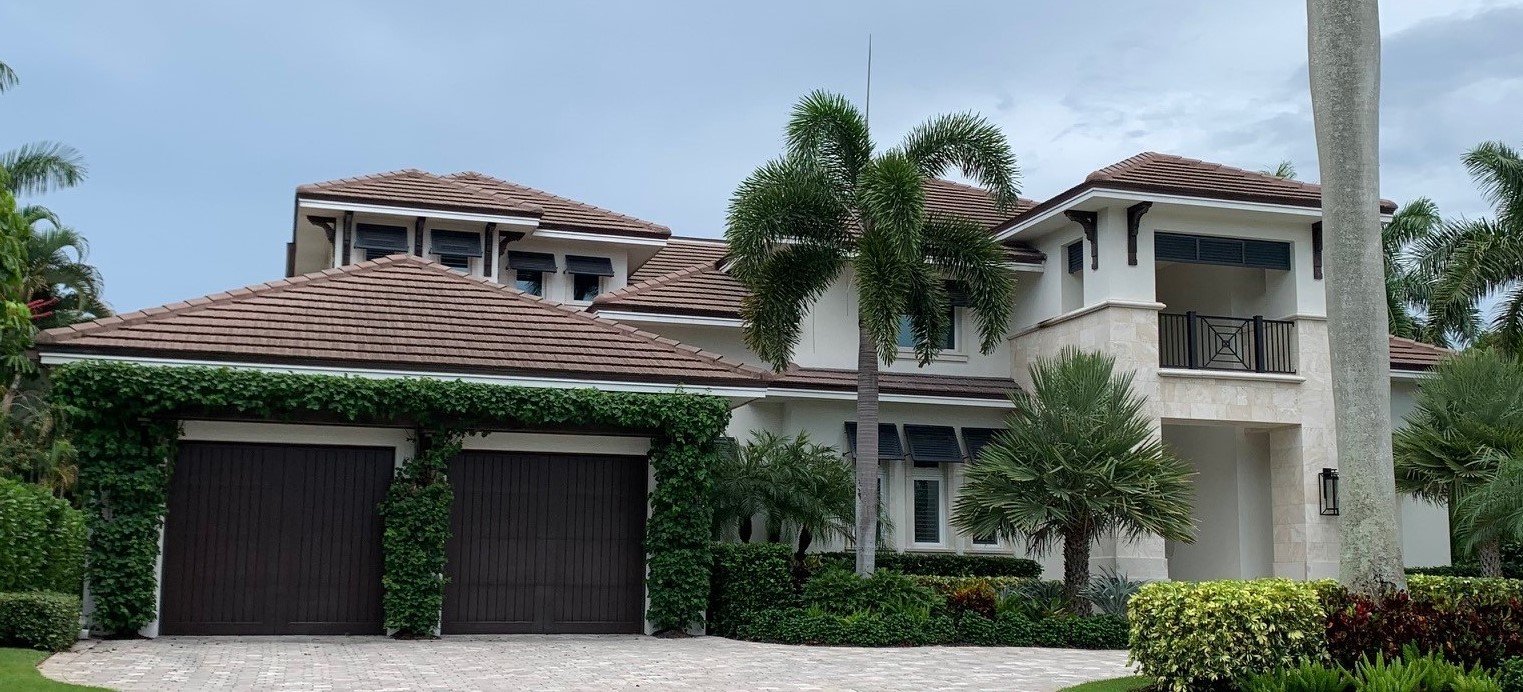 Color image of a 2-story coastal contemporary house with tile roof