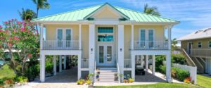 Front elevation color photo of stilt house designed by South Florida Design